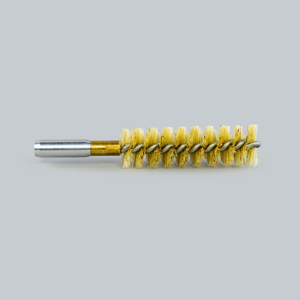 Bore cleaning brush with brass shank on a gray background