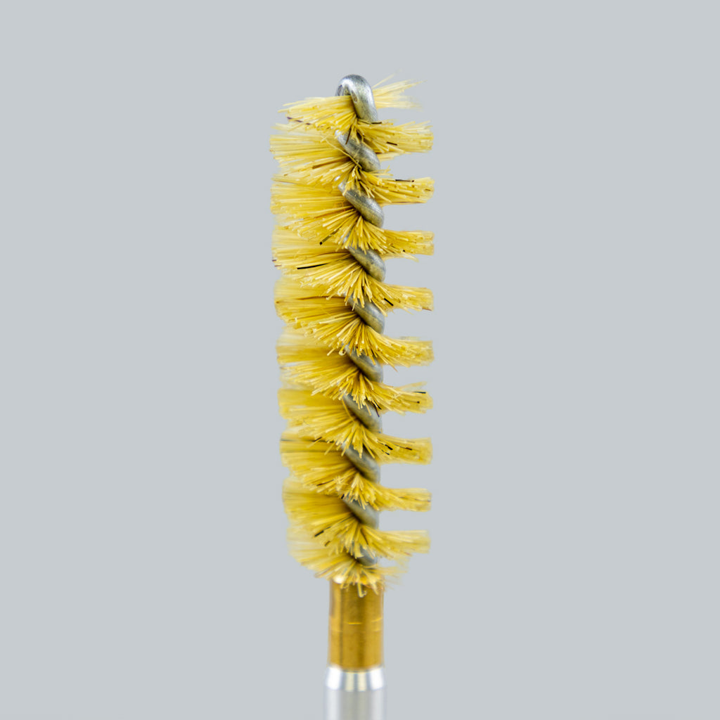 Yellow wire brush on a gray background